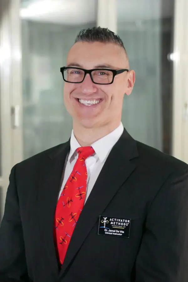 Dr. Jamal DeVita 1 a man in a suit and tie